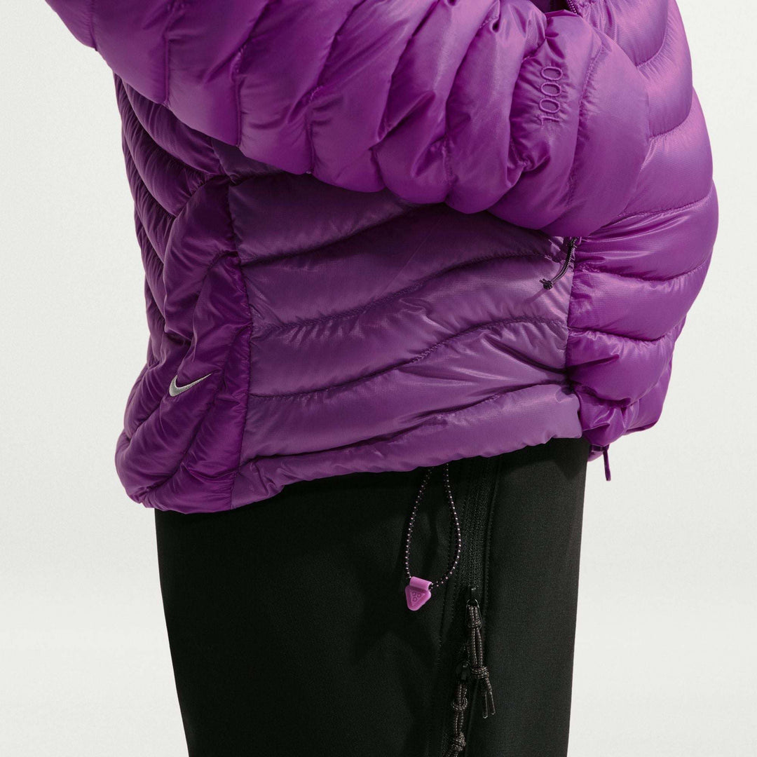 ACG Lava Flow Ultralight purple down jacket in glossy ripstop nylon, with quilted baffles, hood and hem toggle.