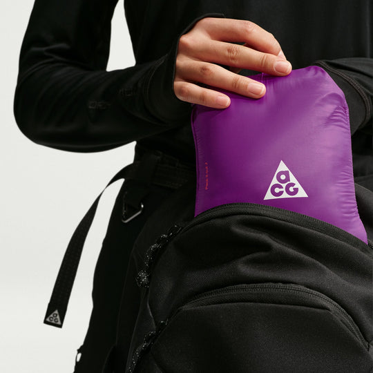 ACG Lava Flow Ultralight jacket in purple nylon, packed into its pocket with a white triangular logo.