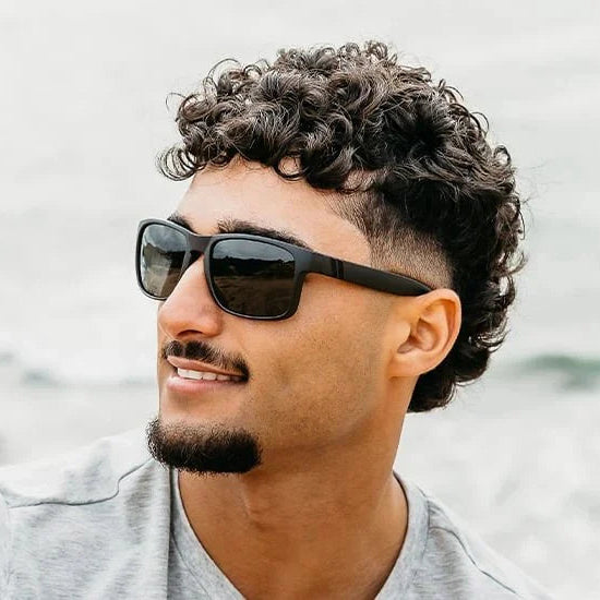 Man wearing sunglasses with a blurred background