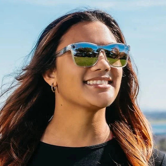 Woman wearing sunglasses with a scenic background