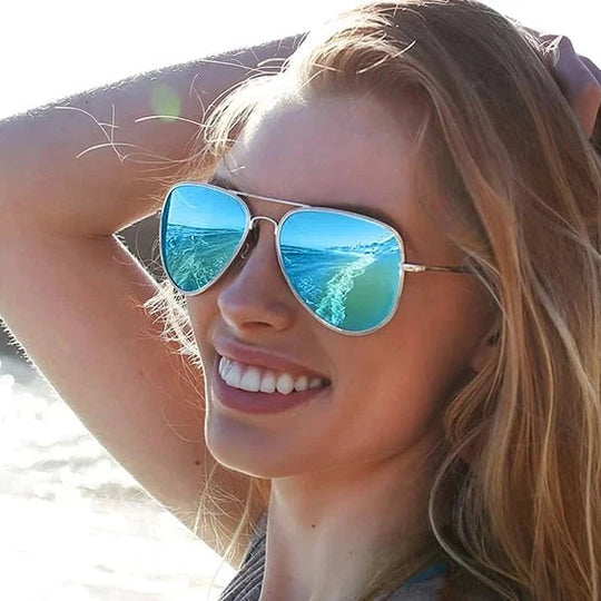Woman wearing reflective sunglasses on a beach