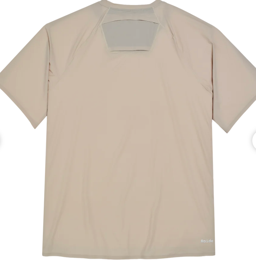 A light beige short-sleeve athletic t-shirt shown from the back, featuring a large rectangular cutout at the upper back with a gray backing, photographed on a white background.