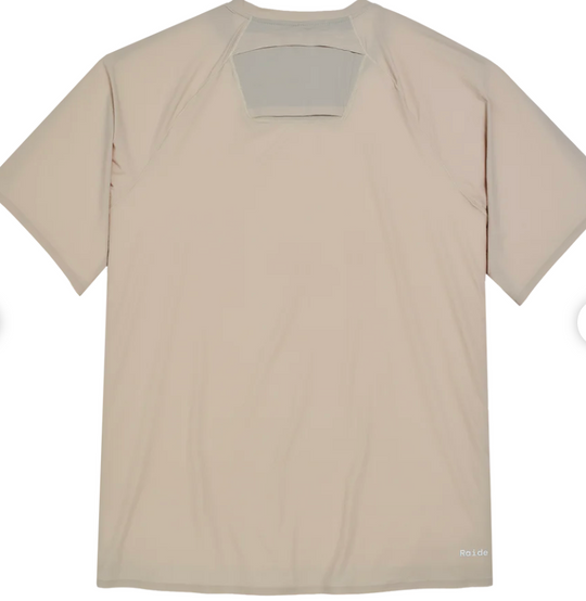 A light beige short-sleeve athletic t-shirt shown from the back, featuring a large rectangular cutout at the upper back with a gray backing, photographed on a white background.