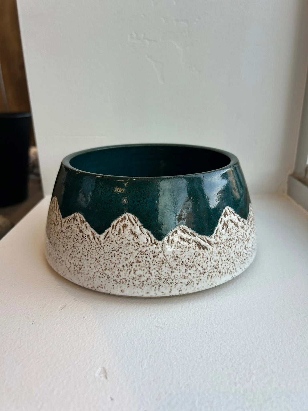 Wondrous Waters Pet Bowl, handcrafted ceramic with a glossy teal glaze and a cream speckled mountain pattern.